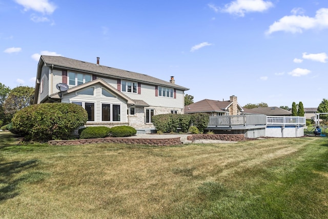 back of property featuring a fenced in pool, a lawn, and a chimney