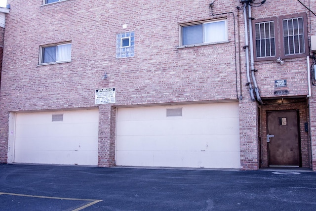 exterior space with a garage and aphalt driveway