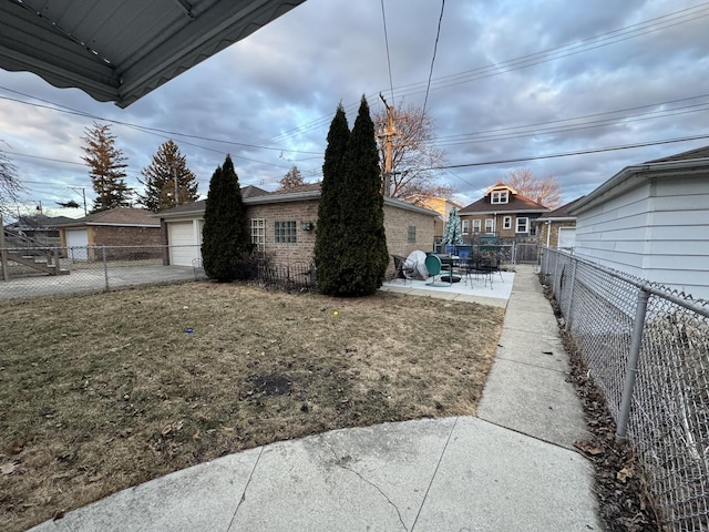 view of home's exterior with a lawn, a fenced backyard, an outdoor structure, a garage, and a patio area