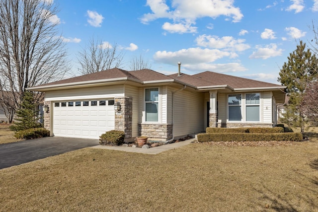 prairie-style house with an attached garage, a front lawn, roof with shingles, stone siding, and driveway