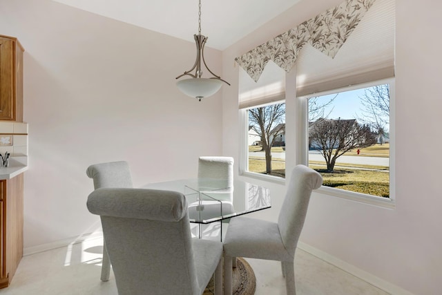 dining space featuring baseboards