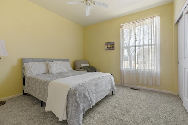 bedroom with baseboards, visible vents, carpet floors, and ceiling fan