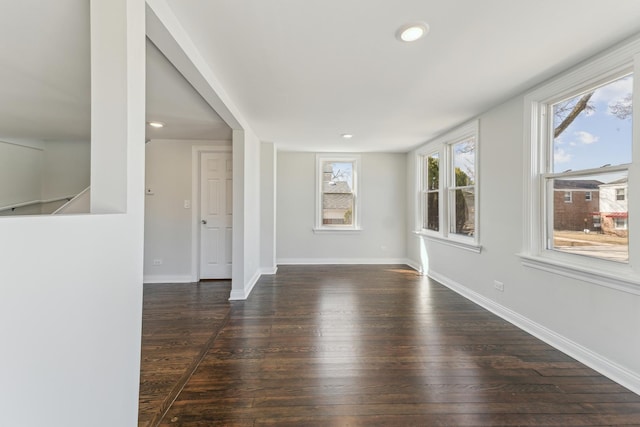 spare room with recessed lighting, baseboards, and wood finished floors