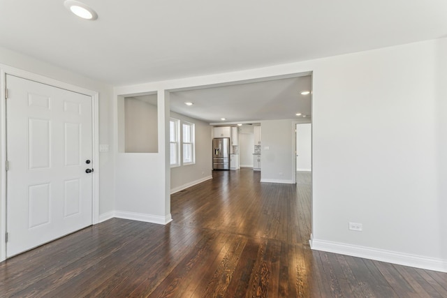 unfurnished living room featuring recessed lighting, baseboards, and dark wood-style flooring