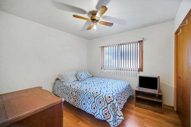 bedroom with wood finished floors and a ceiling fan