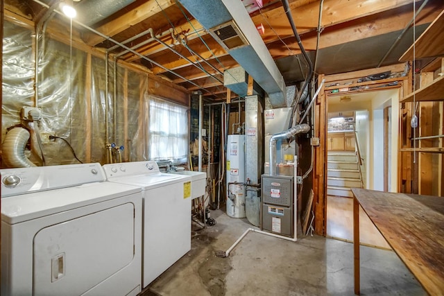 below grade area featuring gas water heater, visible vents, heating unit, and washer and dryer