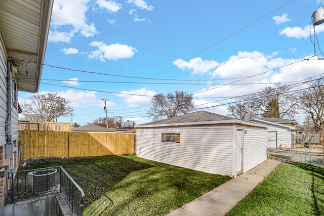 view of yard featuring cooling unit, an outdoor structure, and fence