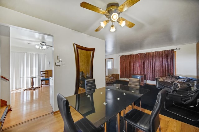 dining space with wood finished floors and ceiling fan