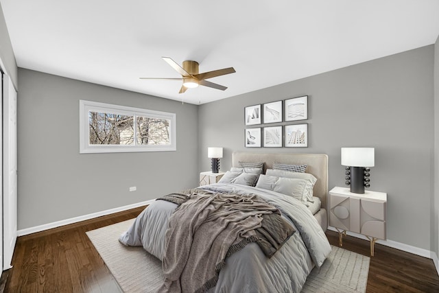 bedroom with ceiling fan, dark wood-type flooring, and baseboards