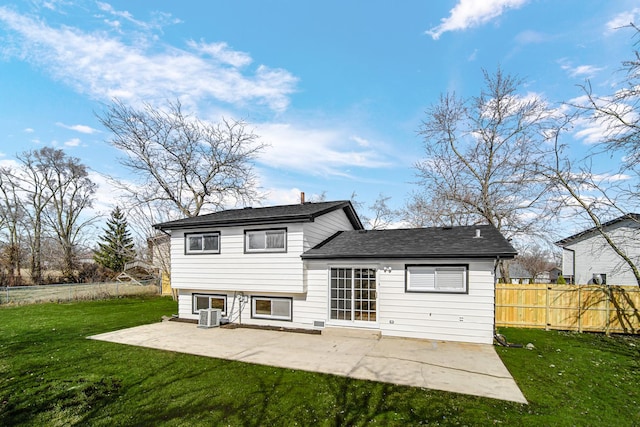 rear view of house featuring central air condition unit, a patio, fence, a yard, and a shingled roof