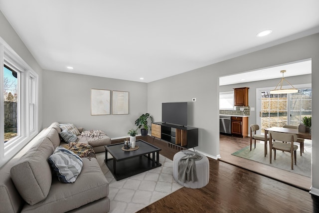 living room featuring light wood finished floors, recessed lighting, and a wealth of natural light