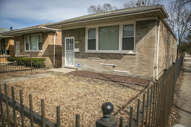 view of front of property featuring brick siding and fence