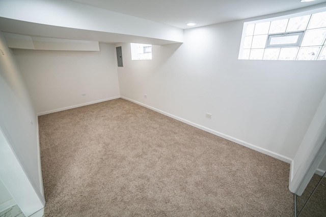 basement featuring recessed lighting, baseboards, and carpet