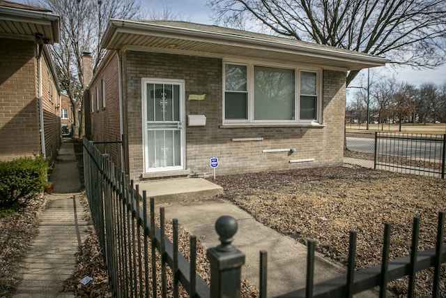 view of front of house with fence and brick siding