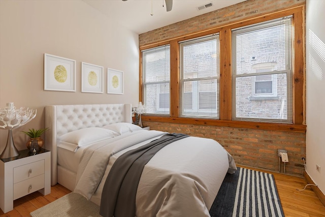 1637 W Pratt Blvd Unit 2W, Chicago, IL 60626 - bedroom featuring light wood-type flooring and brick wall