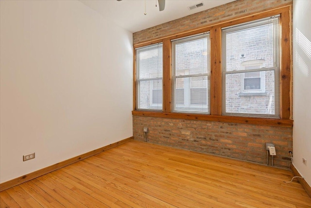 1637 W Pratt Blvd Unit 2W, Chicago, IL 60626 - unfurnished room featuring light wood-type flooring, brick wall, and a ceiling fan