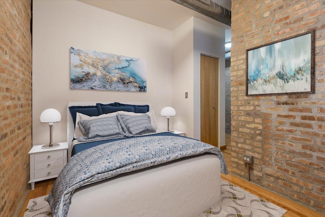 1637 W Pratt Blvd Unit 2W, Chicago, IL 60626 - bedroom with wood finished floors and brick wall