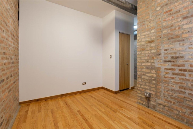1637 W Pratt Blvd Unit 2W, Chicago, IL 60626 - unfurnished room featuring light wood-type flooring and brick wall