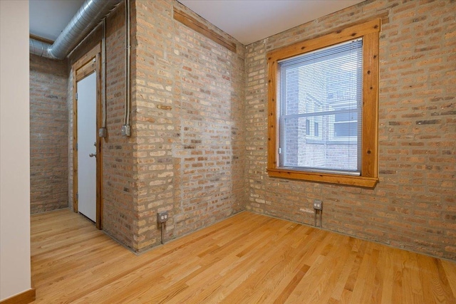 1637 W Pratt Blvd Unit 2W, Chicago, IL 60626 - unfurnished room featuring light wood-type flooring and brick wall