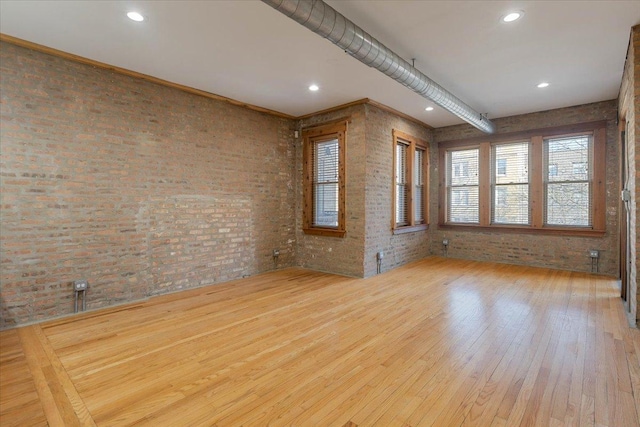 1637 W Pratt Blvd Unit 2W, Chicago, IL 60626 - spare room featuring wood-type flooring, brick wall, and recessed lighting