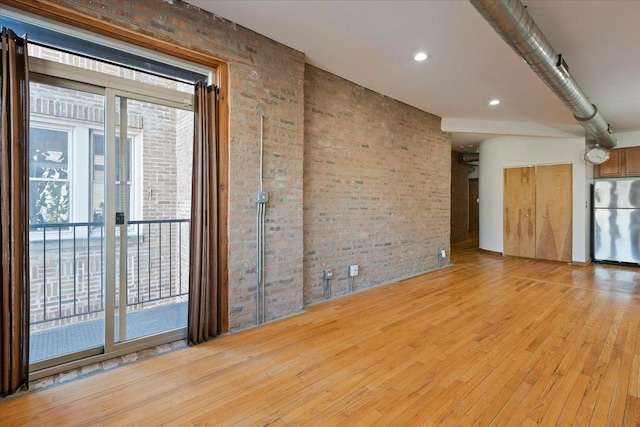1637 W Pratt Blvd Unit 2W, Chicago, IL 60626 - spare room featuring brick wall and light wood finished floors