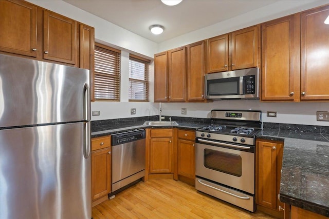 1637 W Pratt Blvd Unit 2W, Chicago, IL 60626 - kitchen featuring stainless steel appliances, brown cabinetry, and light wood-type flooring