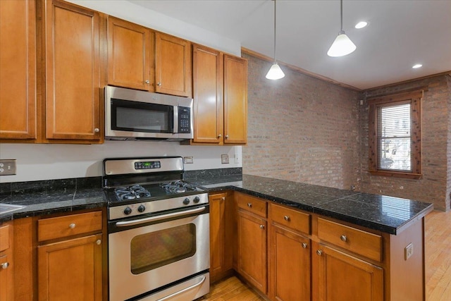 1637 W Pratt Blvd Unit 2W, Chicago, IL 60626 - kitchen with appliances with stainless steel finishes, a peninsula, light wood-type flooring, and brown cabinetry