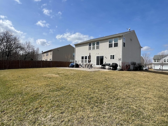 rear view of property featuring a patio, a yard, and fence