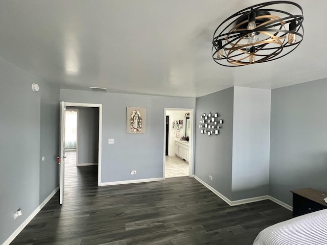 bedroom with visible vents, baseboards, and wood finished floors