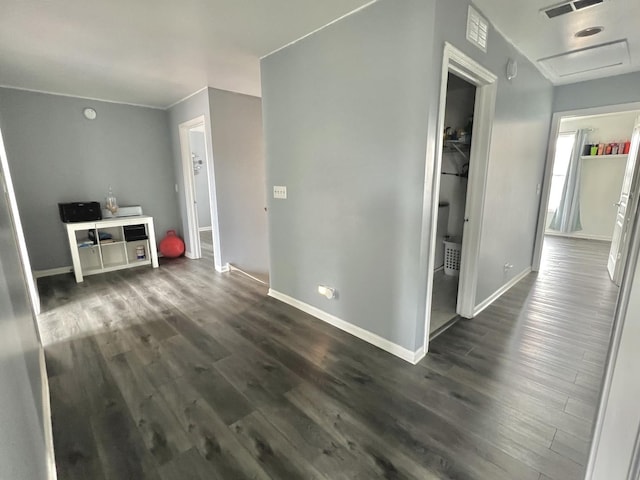 interior space featuring attic access, dark wood-style floors, baseboards, and visible vents