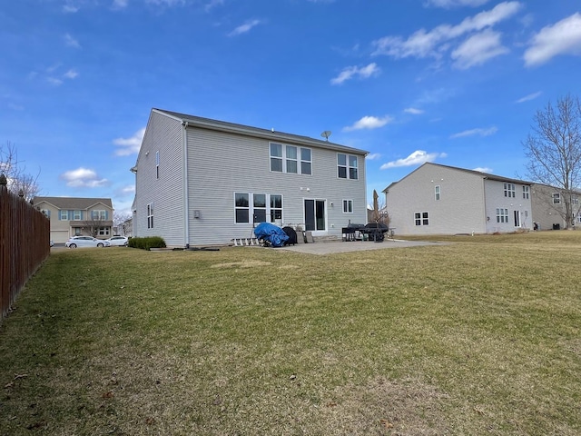 back of house featuring a patio and a yard