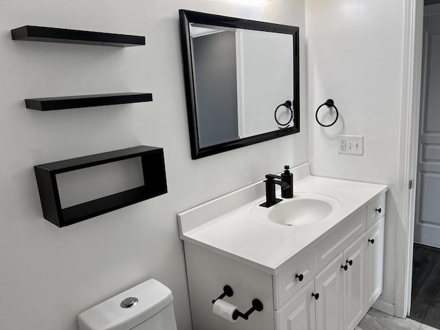 bathroom featuring toilet and vanity