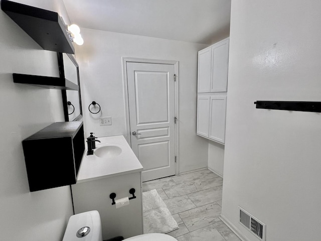 bathroom with visible vents, baseboards, toilet, marble finish floor, and vanity