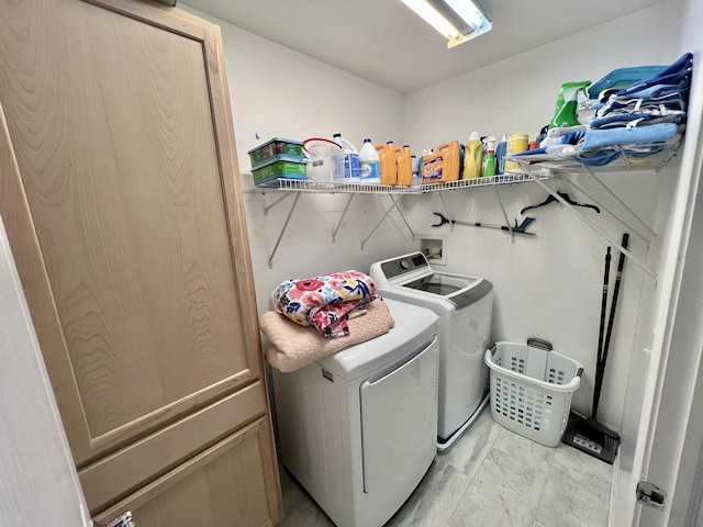 washroom featuring laundry area, separate washer and dryer, and marble finish floor