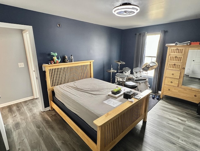 bedroom featuring wood finished floors and baseboards