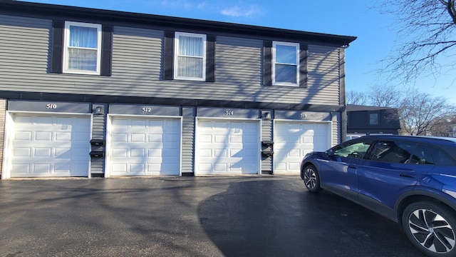 view of home's exterior with an attached garage and driveway