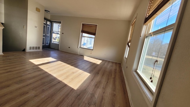 empty room with visible vents and dark wood-style flooring