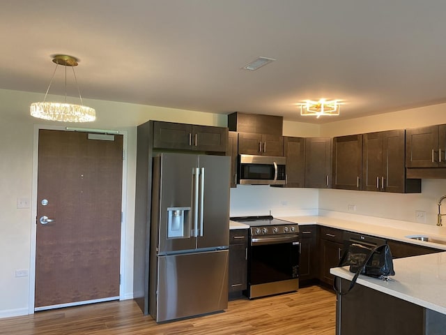200 Park Ave Unit 531, Calumet City, IL 60409 - kitchen with appliances with stainless steel finishes, light wood-type flooring, light countertops, and dark brown cabinets