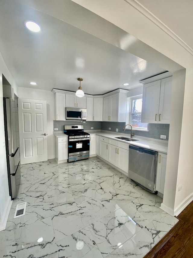 8416 S Bennett Ave, Chicago, IL 60617 - kitchen with decorative backsplash, light countertops, appliances with stainless steel finishes, and a sink