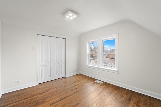 8416 S Bennett Ave, Chicago, IL 60617 - unfurnished bedroom featuring vaulted ceiling, wood finished floors, and baseboards