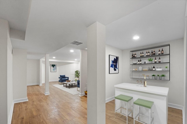 8416 S Bennett Ave, Chicago, IL 60617 - bar featuring visible vents, baseboards, and light wood-style floors