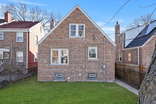 8416 S Bennett Ave, Chicago, IL 60617 - rear view of house featuring brick siding, a lawn, a chimney, and fence