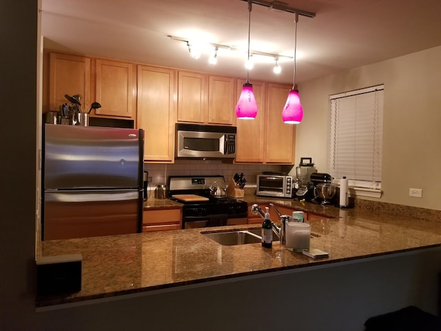 kitchen with tasteful backsplash, a toaster, dark stone countertops, stainless steel appliances, and a sink