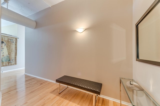 living area with baseboards and light wood-type flooring