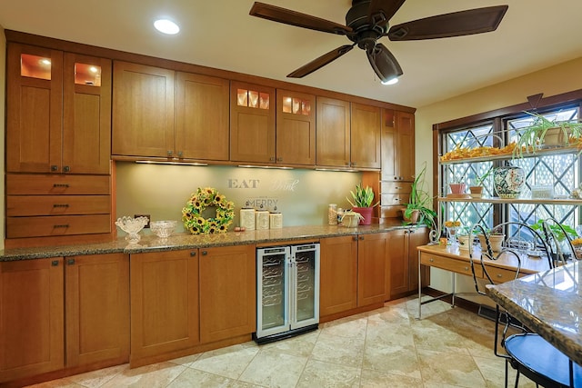 kitchen with stone countertops, glass insert cabinets, wine cooler, and brown cabinets