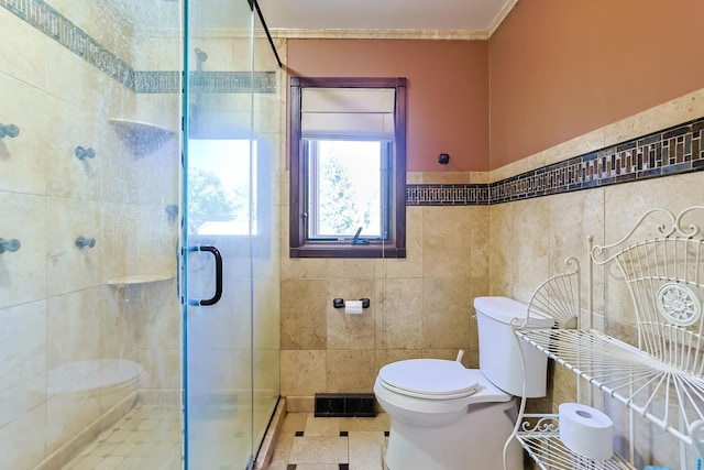 full bathroom with a shower stall, toilet, tile walls, and visible vents