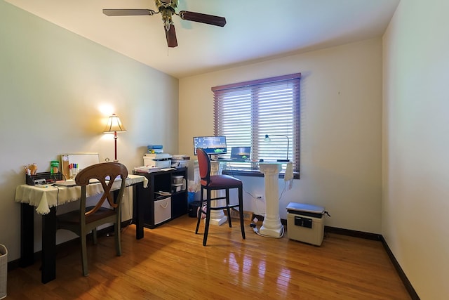 office area with ceiling fan, baseboards, and wood finished floors