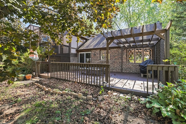 rear view of house with brick siding, a pergola, and a deck