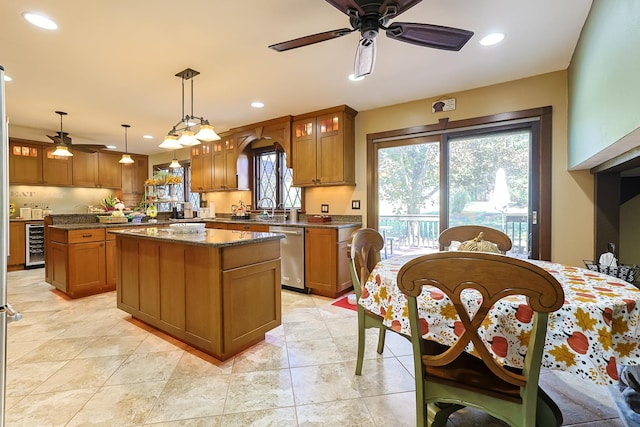 kitchen featuring stainless steel dishwasher, wine cooler, a ceiling fan, and a center island