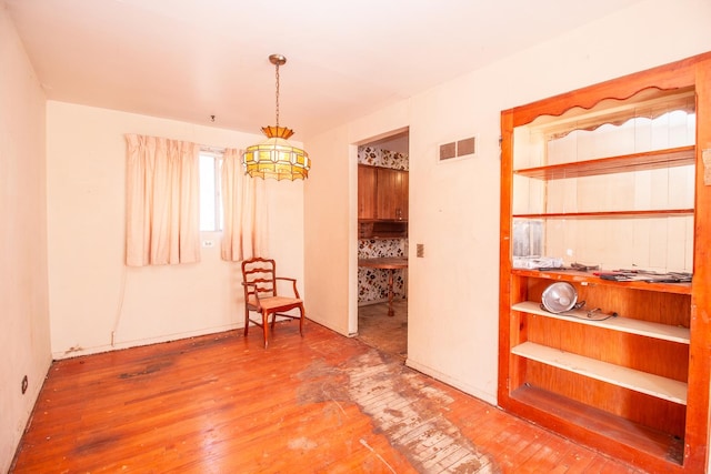 interior space featuring visible vents and hardwood / wood-style flooring